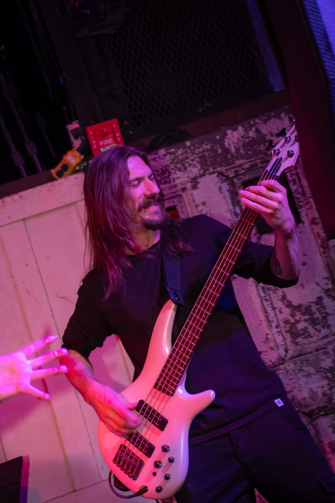 Philippe of BLOODFATE playing bass live on stage
